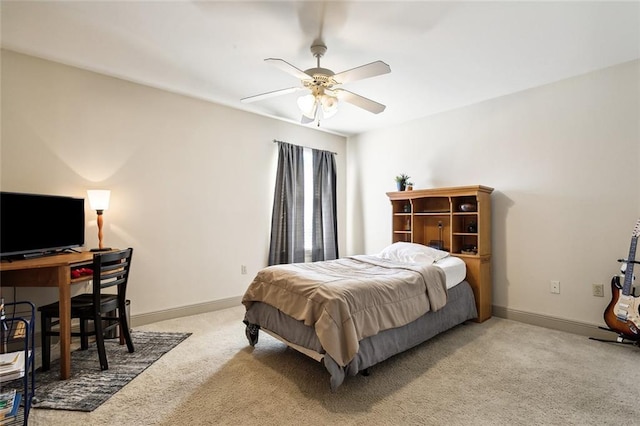 bedroom with light colored carpet, ceiling fan, and baseboards