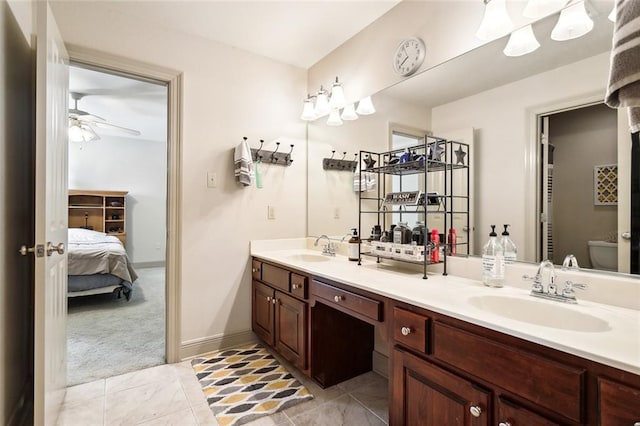 full bathroom with toilet, a sink, ensuite bath, and double vanity