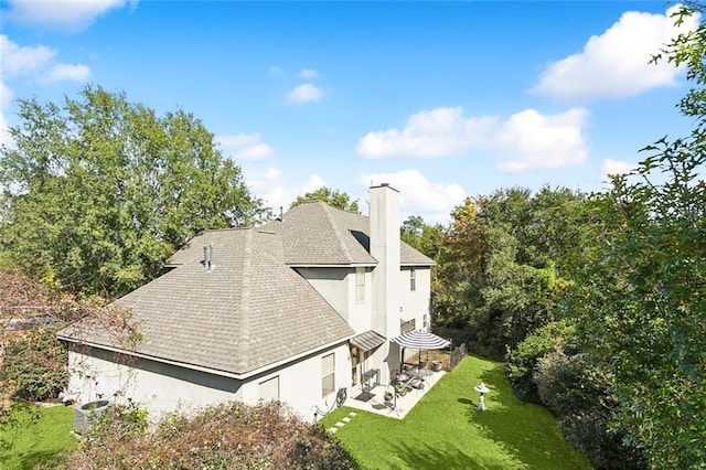 view of home's exterior featuring a lawn and a patio area