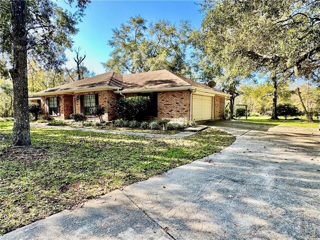 view of front of home with a garage and a front lawn