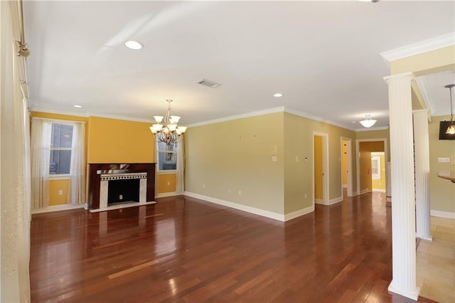 unfurnished living room featuring ornate columns, ornamental molding, and dark hardwood / wood-style flooring