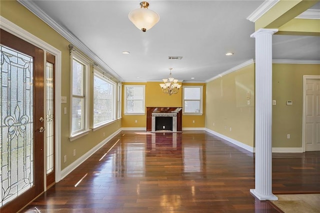 interior space featuring visible vents, ornamental molding, wood finished floors, and decorative columns