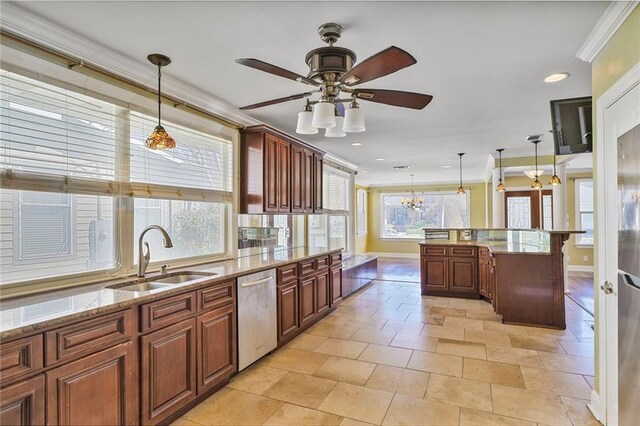 kitchen with pendant lighting, crown molding, a sink, light stone countertops, and dishwasher