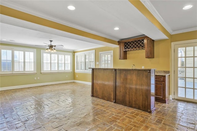 bar featuring brick floor, baseboards, ornamental molding, and recessed lighting