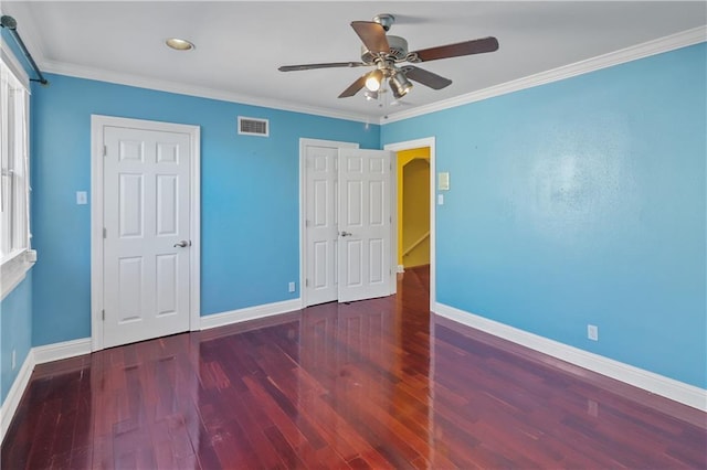 unfurnished bedroom featuring dark hardwood / wood-style flooring, crown molding, and ceiling fan