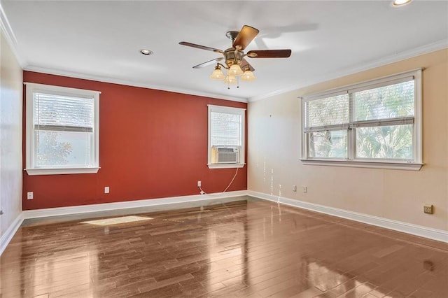 empty room featuring ornamental molding, plenty of natural light, and hardwood / wood-style floors