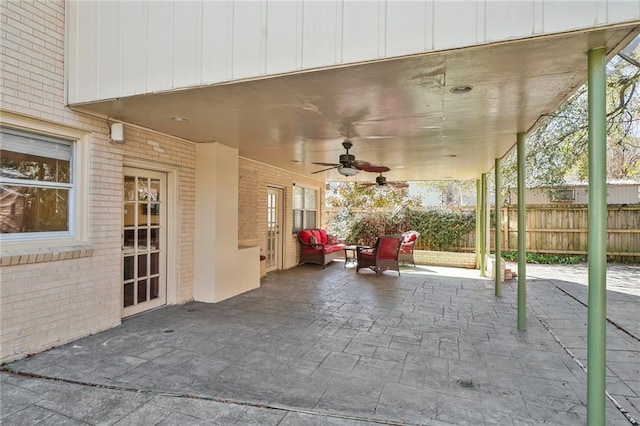 view of patio / terrace with fence and a ceiling fan