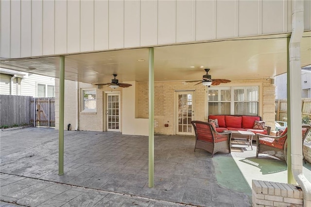 view of patio featuring fence, an outdoor living space, and a ceiling fan