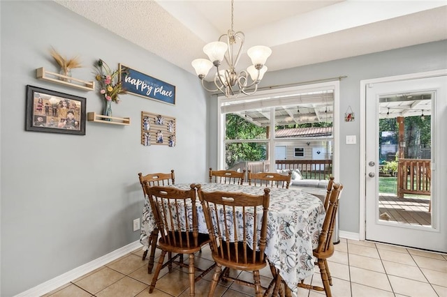 dining space featuring a notable chandelier, light tile patterned floors, and plenty of natural light