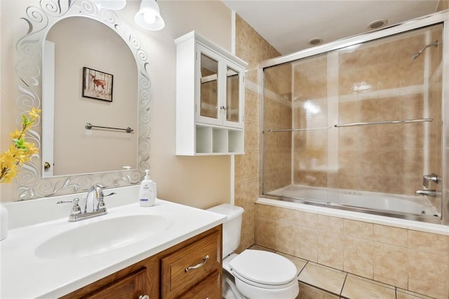 full bathroom with toilet, vanity, tile patterned flooring, and shower / bath combination with glass door