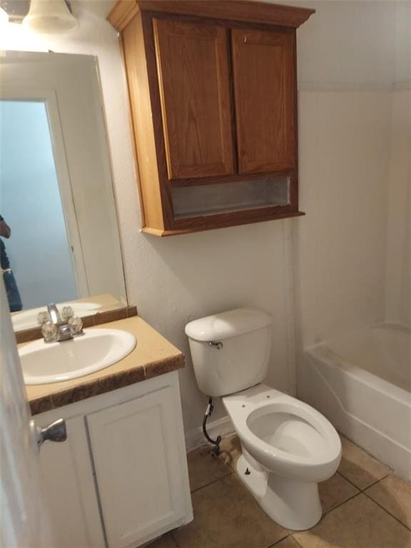 bathroom featuring toilet, vanity, and tile patterned floors