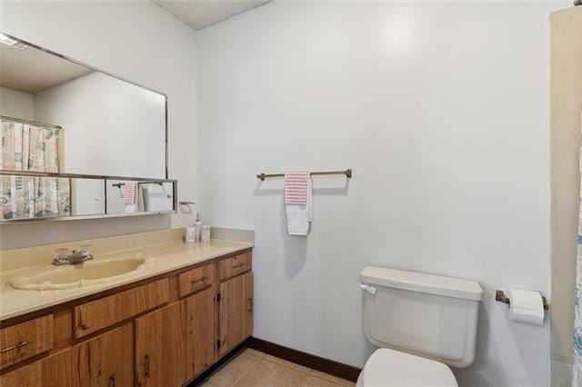 bathroom with vanity, tile patterned floors, and toilet