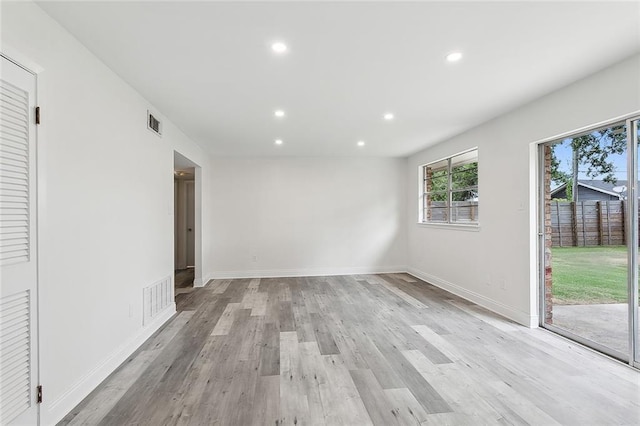 empty room with light hardwood / wood-style flooring