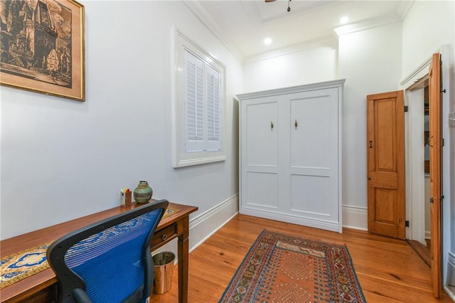 foyer with ornamental molding and light hardwood / wood-style flooring