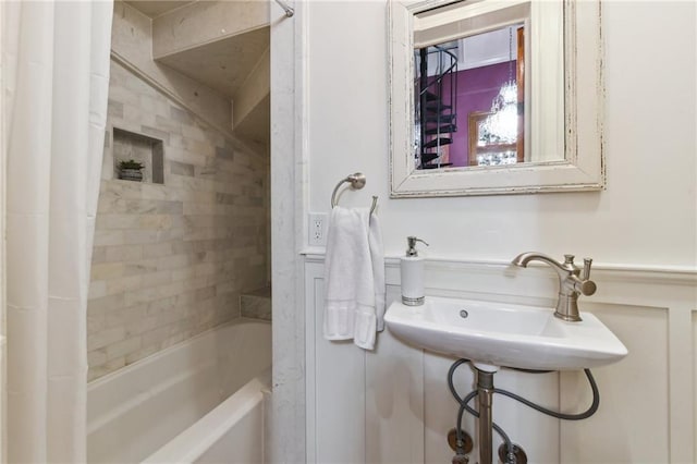 bathroom featuring sink and shower / bathtub combination with curtain