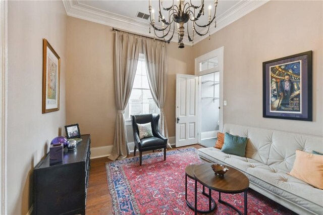 820B Saint Ann St, New Orleans, LA 70116 - living area featuring a chandelier, crown molding, wood finished floors, and baseboards