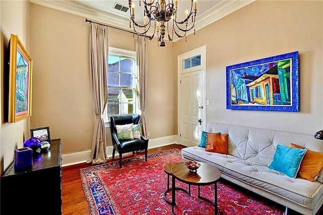 820B Saint Ann St, New Orleans, LA 70116 - living area with crown molding, a chandelier, baseboards, and wood finished floors