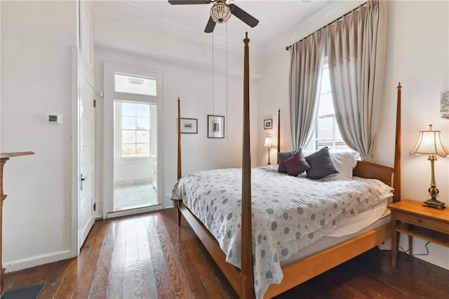 bedroom with dark wood-type flooring, ceiling fan, and ornamental molding