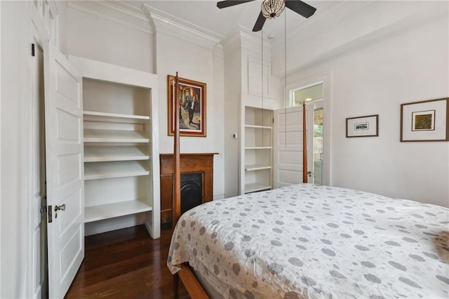 bedroom with crown molding, ceiling fan, and dark hardwood / wood-style floors