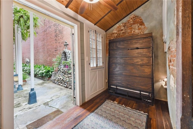 foyer entrance featuring lofted ceiling, dark wood-type flooring, ceiling fan, and wood ceiling