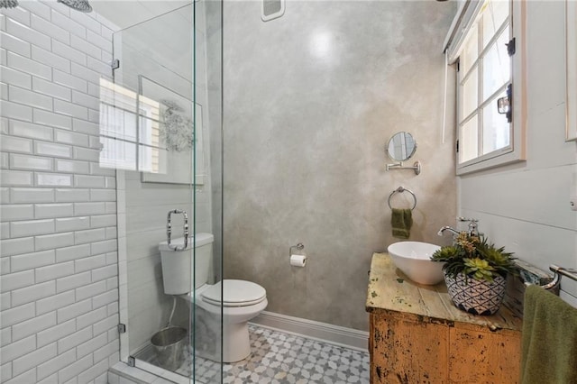 bathroom featuring vanity, walk in shower, plenty of natural light, and toilet