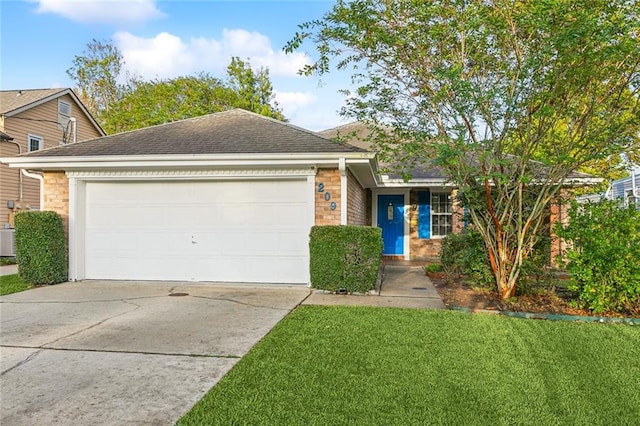 view of front of property featuring a front lawn, a garage, and central AC