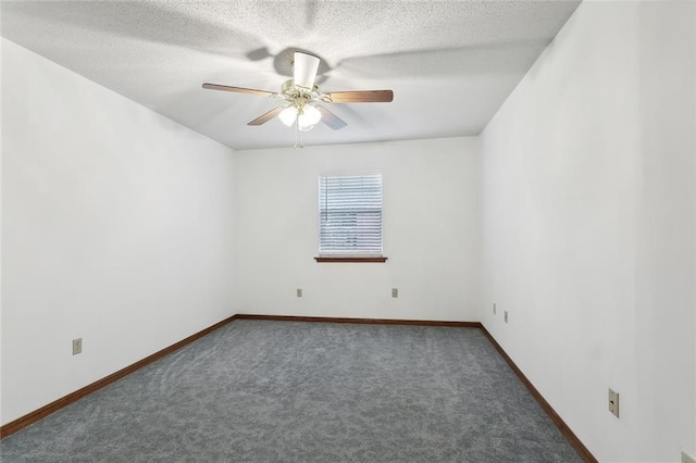 unfurnished room featuring ceiling fan, dark carpet, and a textured ceiling