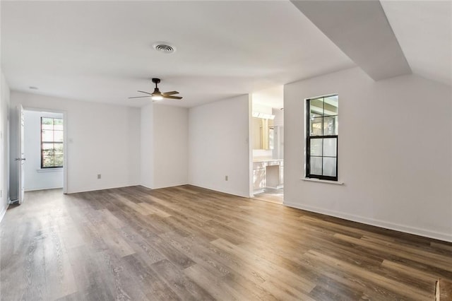 unfurnished living room with hardwood / wood-style flooring, ceiling fan, and lofted ceiling