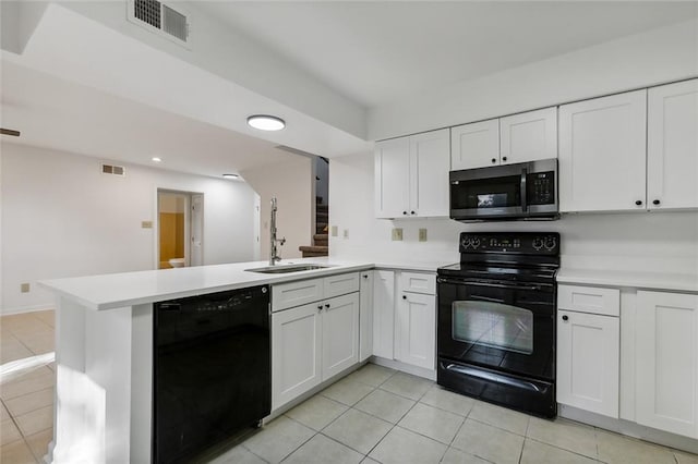 kitchen featuring kitchen peninsula, sink, black appliances, light tile patterned floors, and white cabinetry