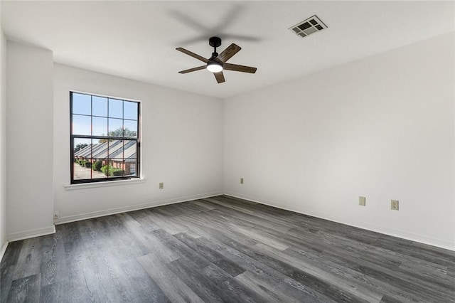 unfurnished room featuring ceiling fan and dark wood-type flooring