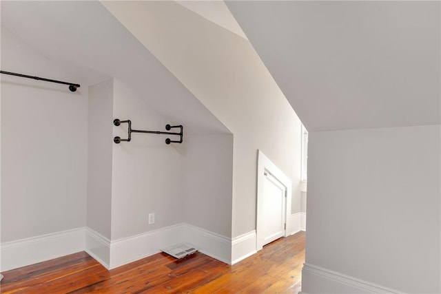 bonus room with baseboards, vaulted ceiling, and hardwood / wood-style flooring