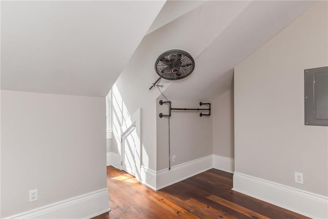 bonus room with dark wood-type flooring, electric panel, and lofted ceiling