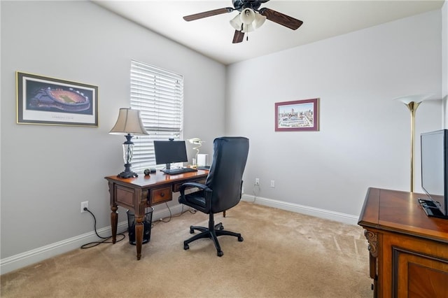 office space featuring light carpet and ceiling fan