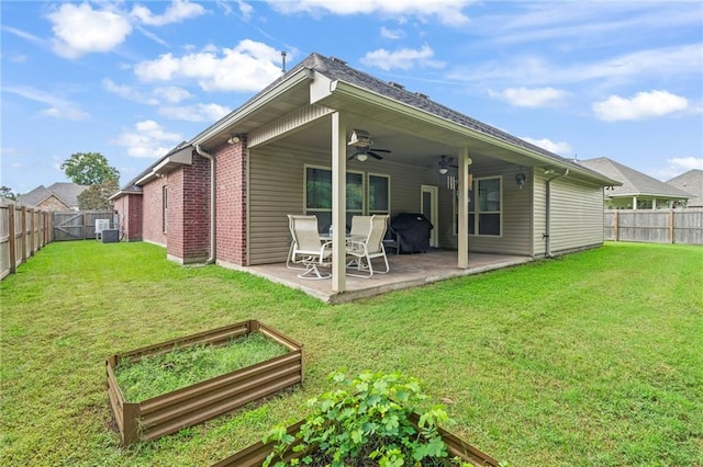 back of property featuring central air condition unit, a patio, ceiling fan, and a lawn