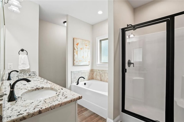 bathroom with independent shower and bath, vanity, and wood-type flooring