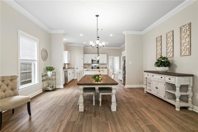 dining room with dark hardwood / wood-style flooring, an inviting chandelier, and ornamental molding