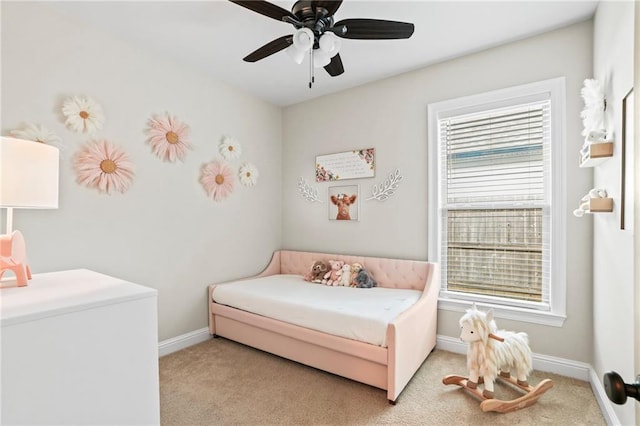 bedroom featuring light colored carpet and ceiling fan