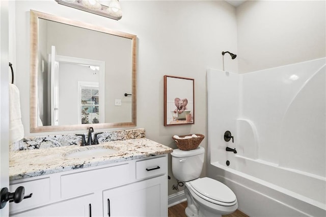 full bathroom with hardwood / wood-style flooring, shower / tub combination, vanity, and toilet