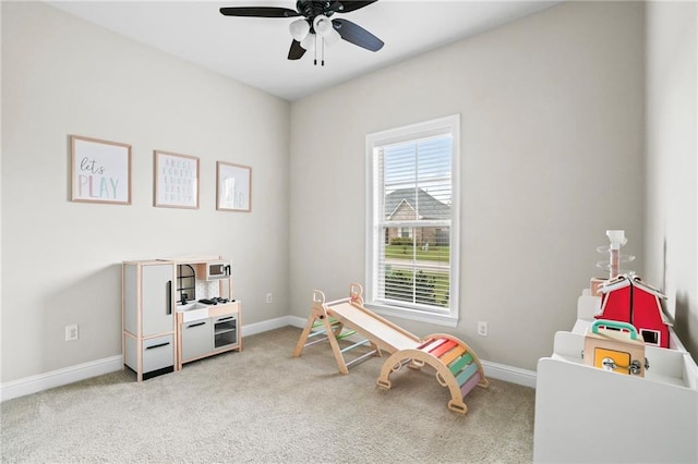 game room featuring ceiling fan and light carpet