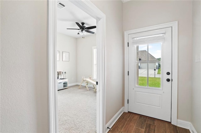 entryway with ceiling fan and dark hardwood / wood-style flooring