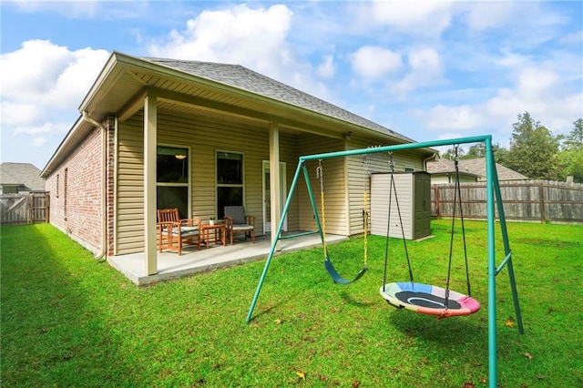 back of property with a patio and a yard