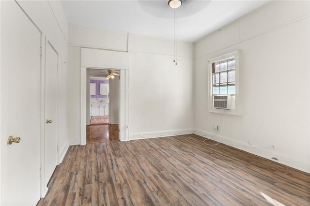 unfurnished room featuring ceiling fan, cooling unit, and dark hardwood / wood-style flooring