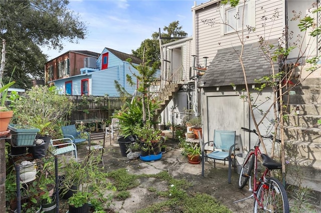 639 Independence St, New Orleans, LA 70117 - rear view of house with stairs and a patio area