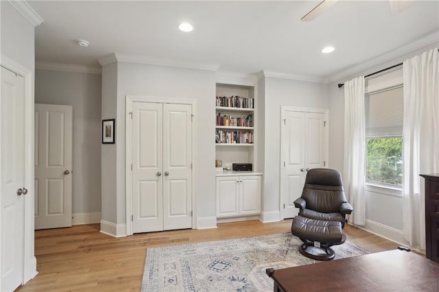 sitting room with light hardwood / wood-style flooring and ornamental molding