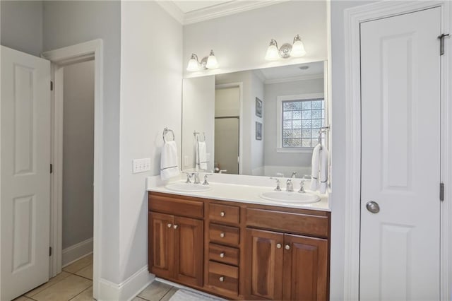 bathroom with tile patterned flooring, a bathtub, vanity, and crown molding