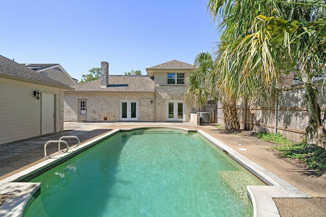 view of swimming pool with central AC and a patio area