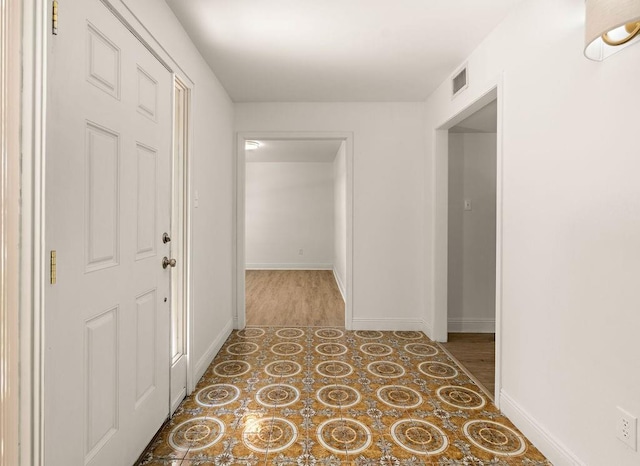 corridor with hardwood / wood-style flooring