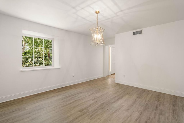 empty room with hardwood / wood-style flooring