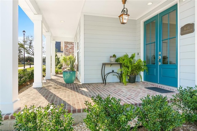 view of exterior entry with a porch