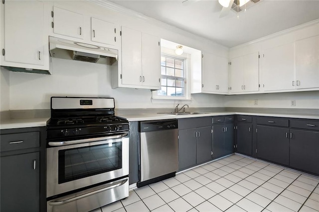 kitchen featuring white cabinets, appliances with stainless steel finishes, and light tile patterned floors